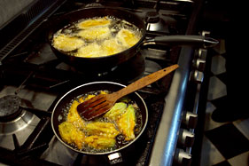 Preparing fried courgette flowers and butterflied sardines for lunch